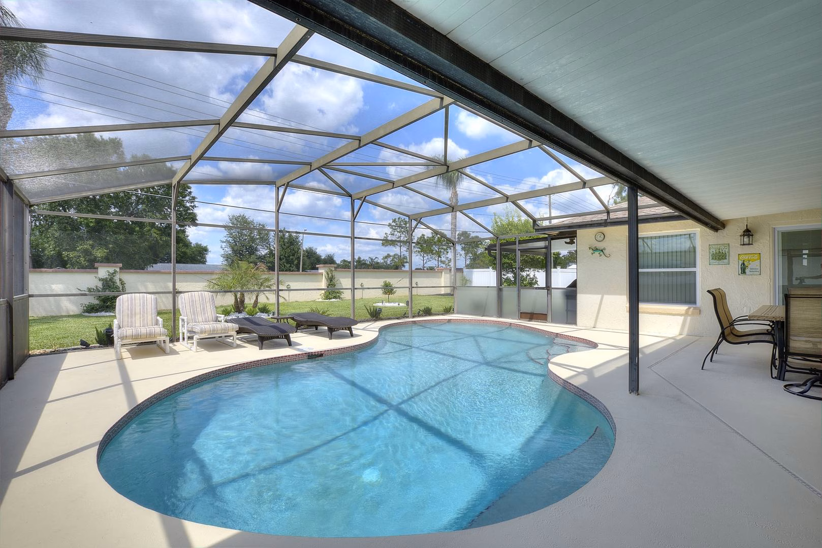 Screened pool with garden beyond