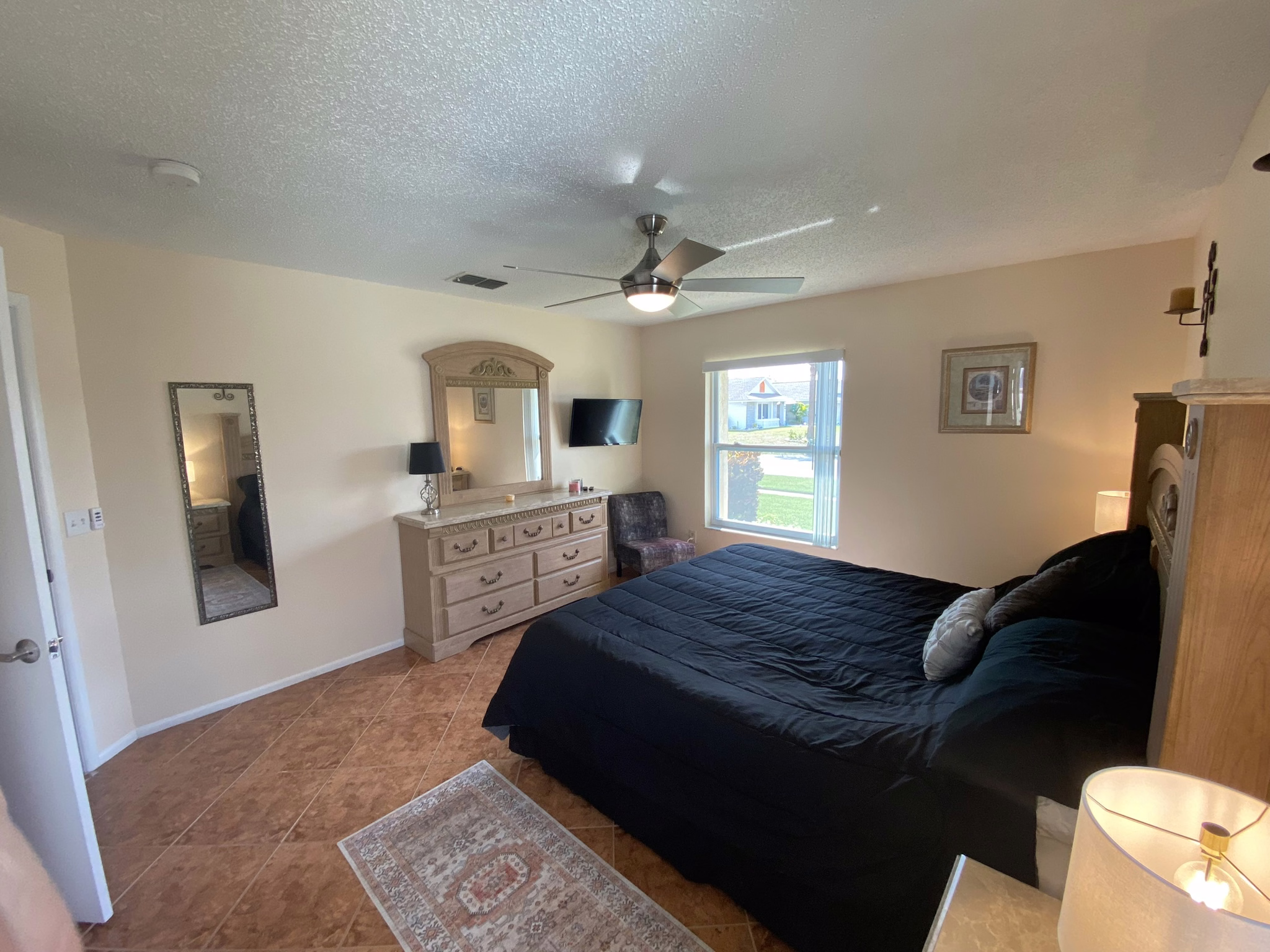 Master bedroom with dresser and TV